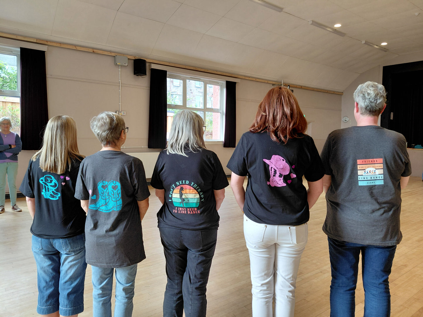 Line dancing T-shirts in various sizes, small on left, 2 mediums a large and 2xl